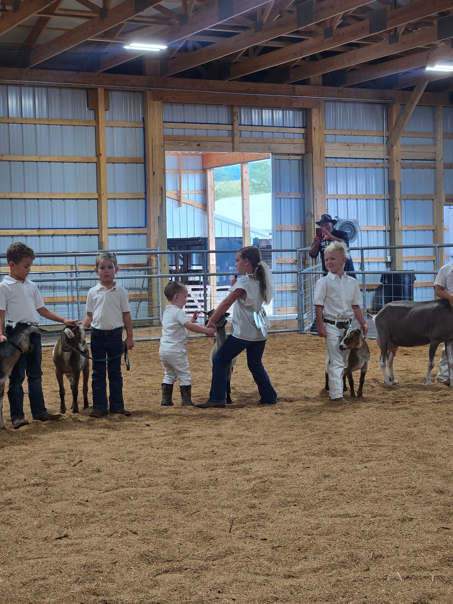 Photo of my daughter and nephew showing their dairy goat together.